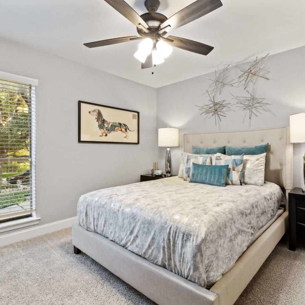 Cozy bedroom with ceiling fan at The Haven on Chisholm Trail in Fort Worth, Texas