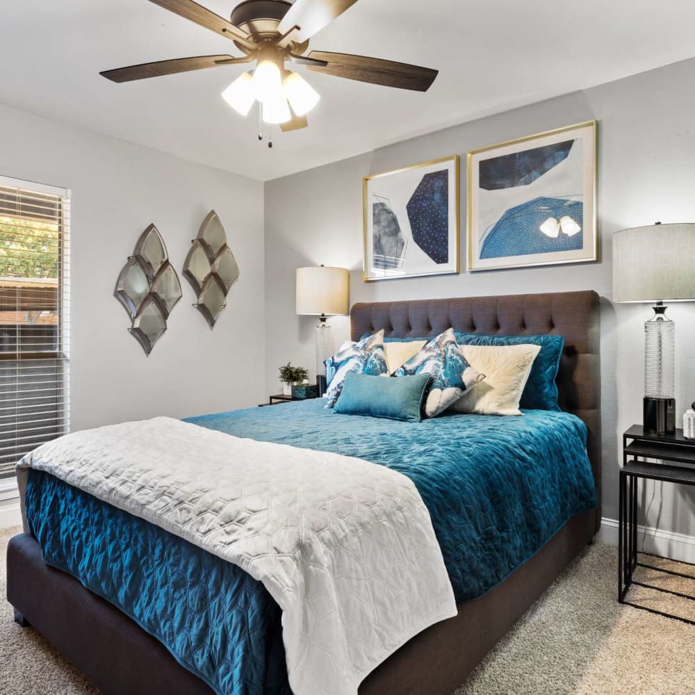 Comfortable bedroom with plush carpeting at The Haven on Chisholm Trail in Fort Worth, Texas