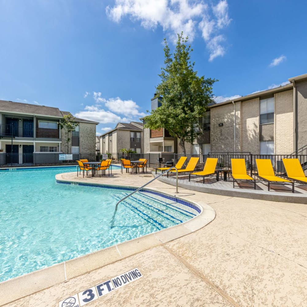 Lounge chairs surround the pool at The Landing at Clear Lake in Webster, Texas