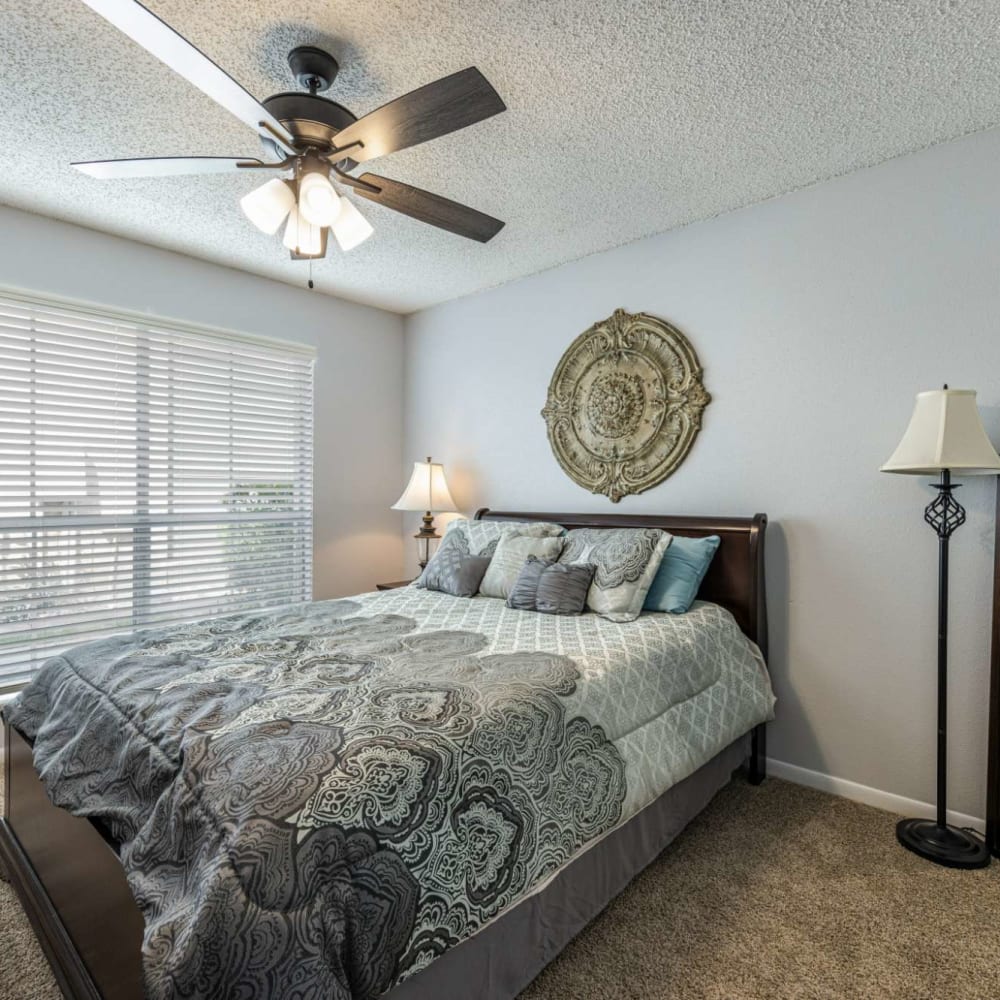 Bedroom with plush carpeting at The Landing at Clear Lake in Webster, Texas