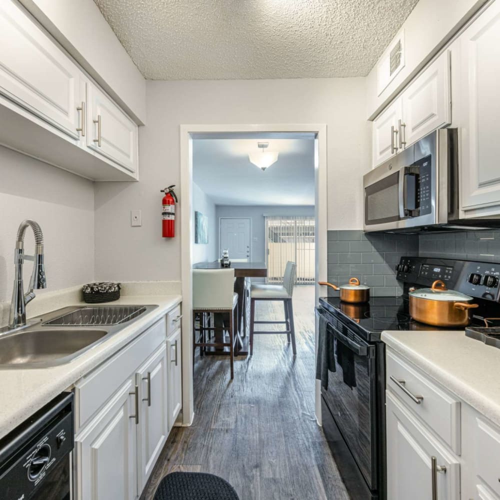 Modern kitchen with black appliances at The Landing at Clear Lake in Webster, Texas