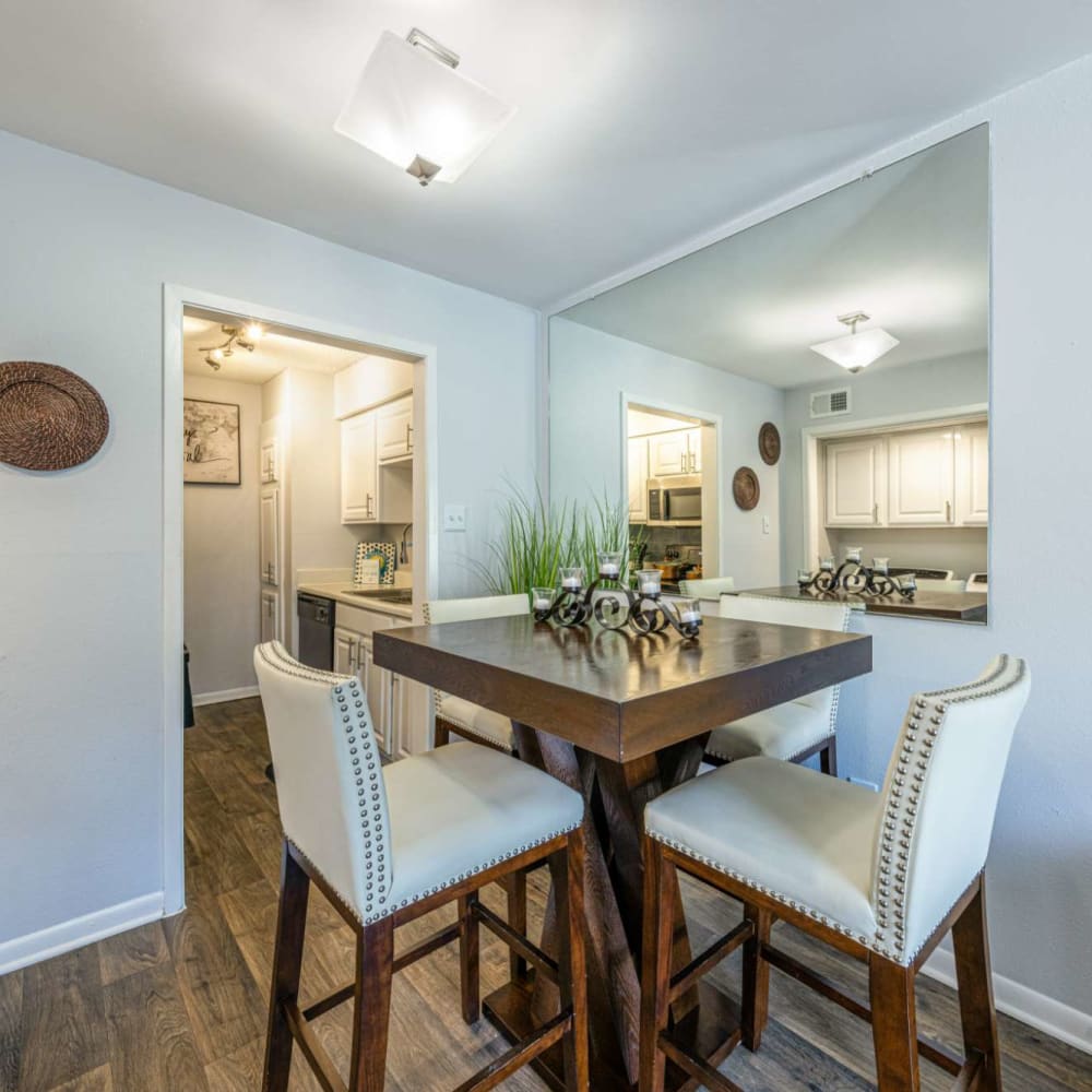 Dinning table and chairs on wood-style flooring at The Landing at Clear Lake in Webster, Texas