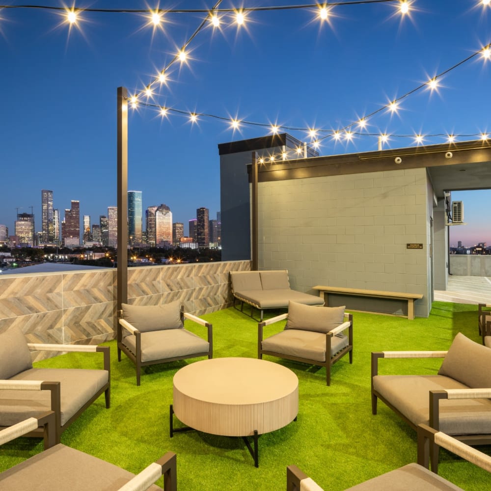 Outdoor courtyard with seating and city skyline views at Bellrock Sawyer Yards in Houston, Texas