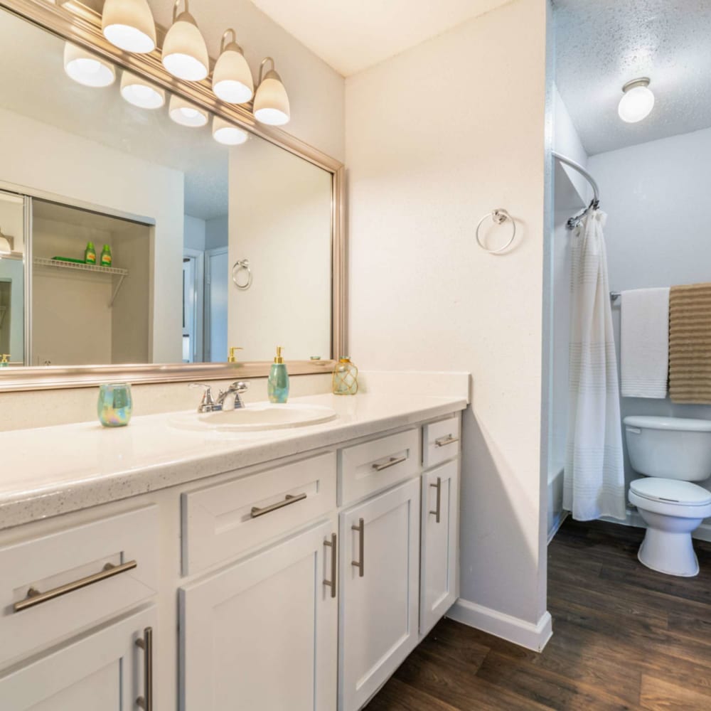 Bathroom with bright lighting at Waterside Apartments in Houston, Texas