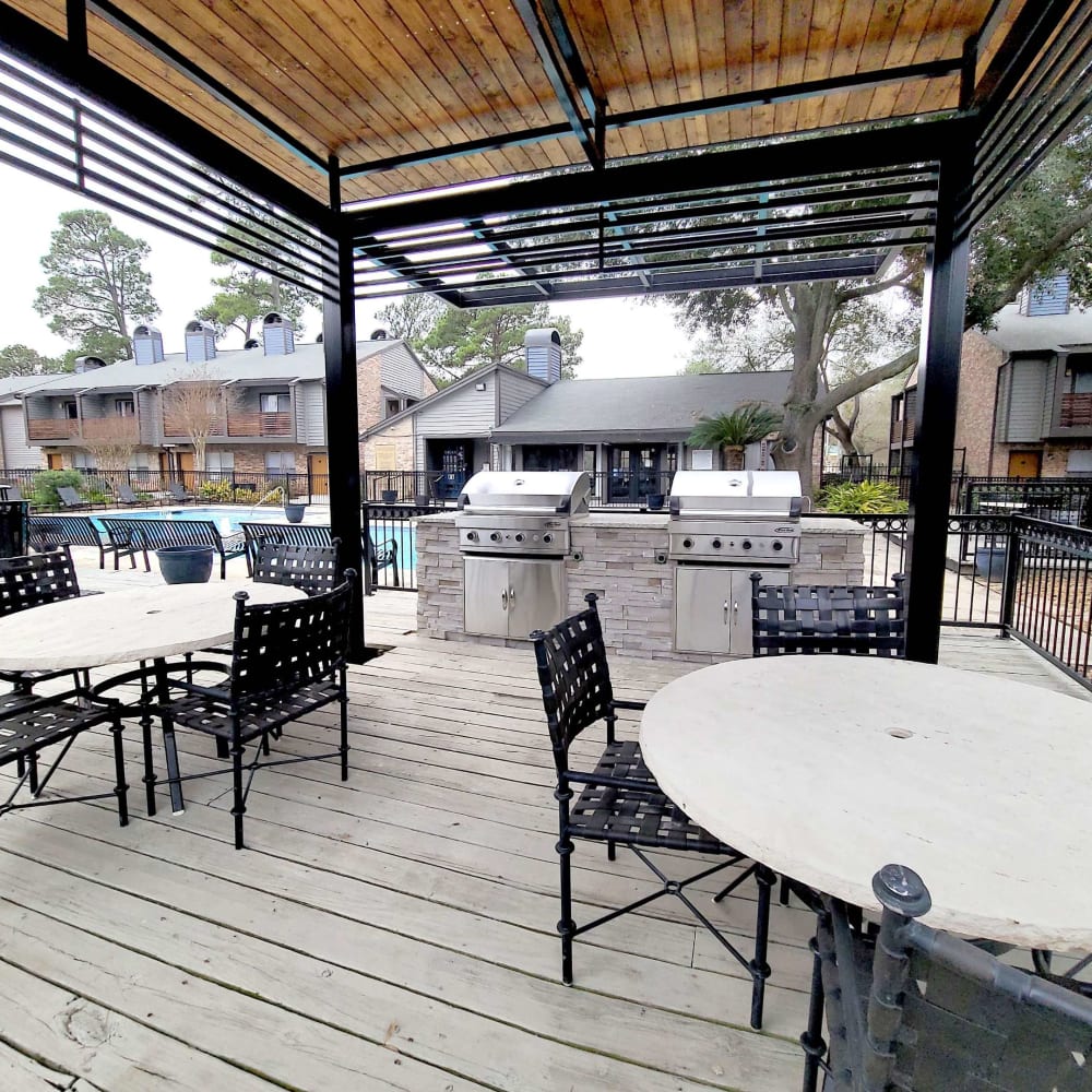 Patio table and chairs around the pool area at Carrara at Cypress Creek in Spring, Texas