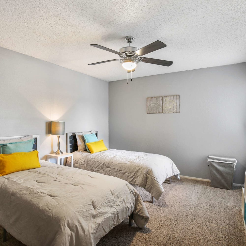 Bedroom with two beds and a ceiling fan at The Hub at Chisolm Trail in Fort Worth, Texas