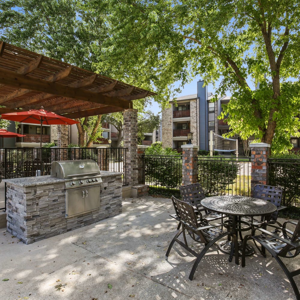 Another covered barbeque area with patio table and chairs at The Hub at Chisolm Trail in Fort Worth, Texas