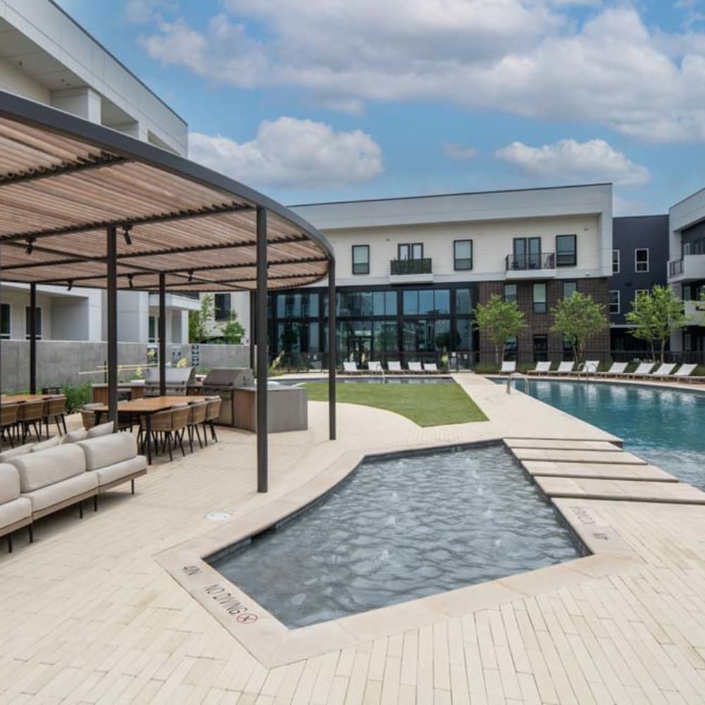 Poolside with bench at Mezzo Apartments in Aubrey
