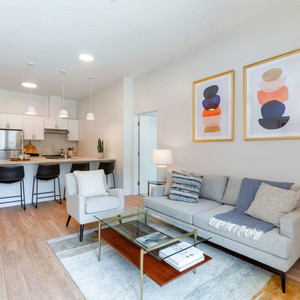 Modern living space with wall art looking towards kitchen at Metro Green Court in Stamford, Connecticut