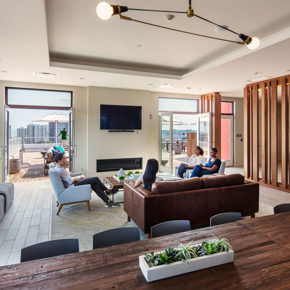 Lobby area with leather couch and TV at Metro Green Court in Stamford, Connecticut