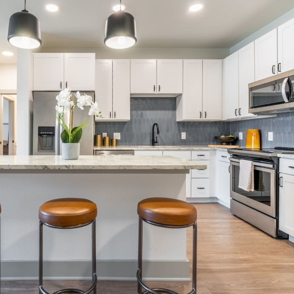 Bar seating at a kitchen island in an apartment at Cypress McKinney Falls in Austin, Texas