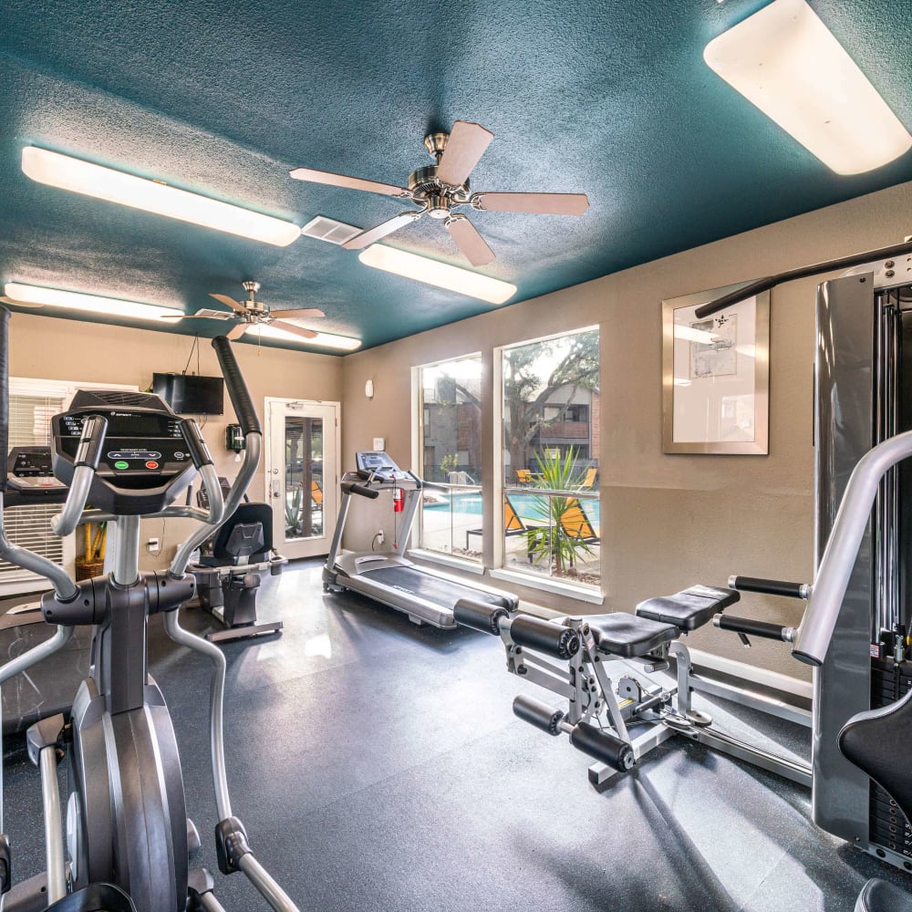 Fitness center with pool views at The Edge at Clear Lake in Webster, Texas