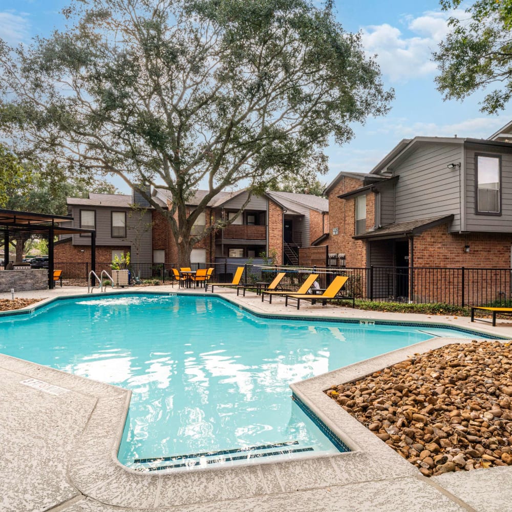 Large swimming pool with lounge seating at The Edge at Clear Lake in Webster, Texas