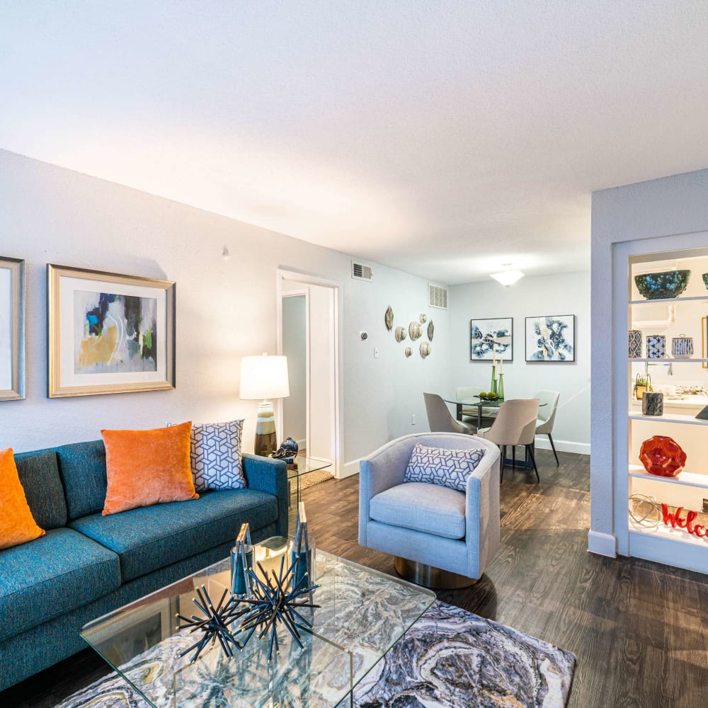 Modern living space with wood-style flooring at The Edge at Clear Lake in Webster, Texas