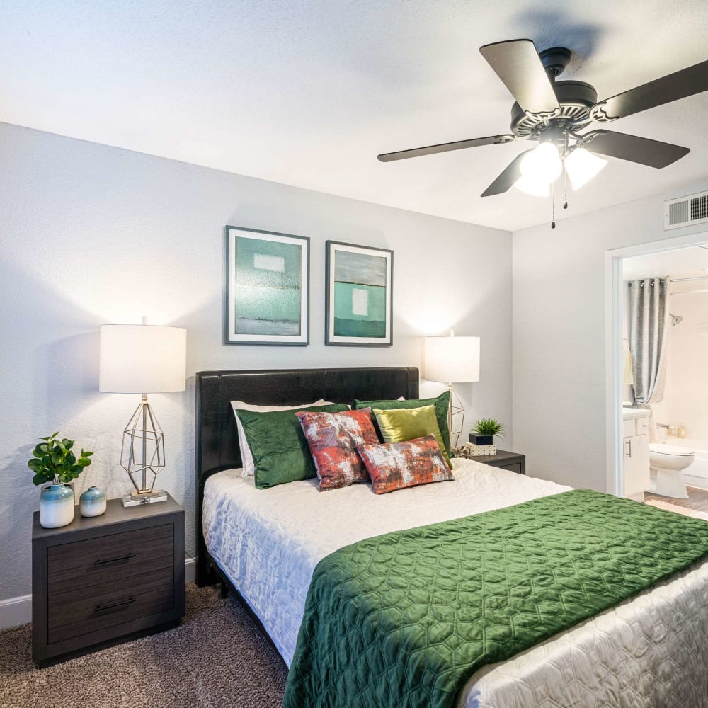 Modern bedroom with plush carpeting at The Edge at Clear Lake in Webster, Texas