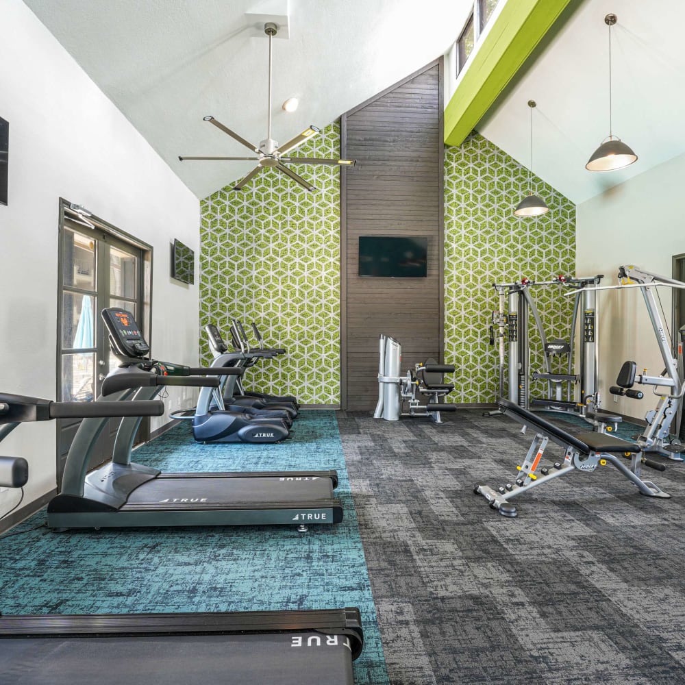 Fitness center with ceiling fans and padded flooring at The Madison on the Lake in Houston, Texas