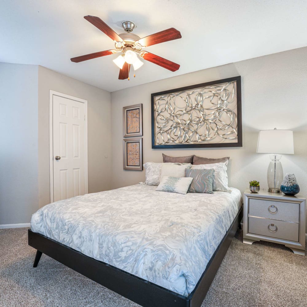 Modern bedroom with a ceiling fan at The Madison on the Lake in Houston, Texas