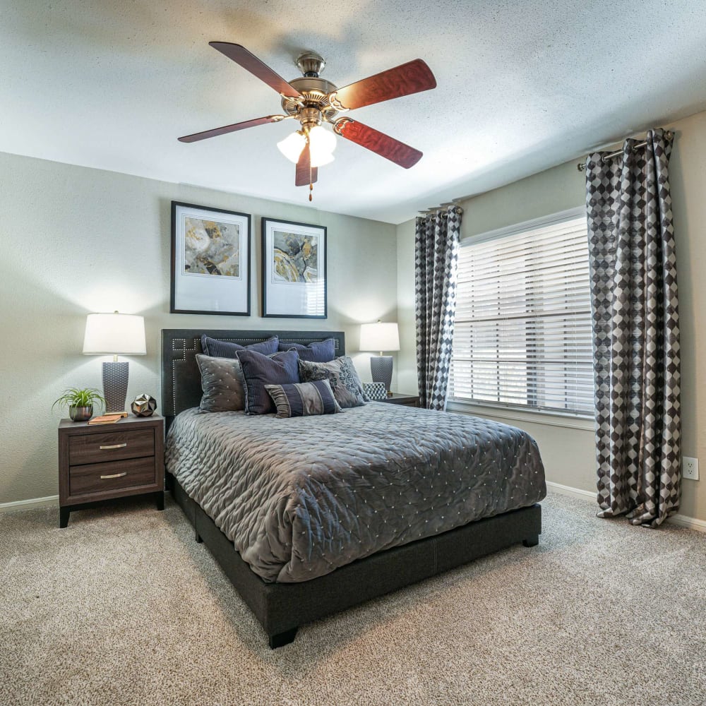 Modern bedroom with plush carpeting at The Madison on the Lake in Houston, Texas