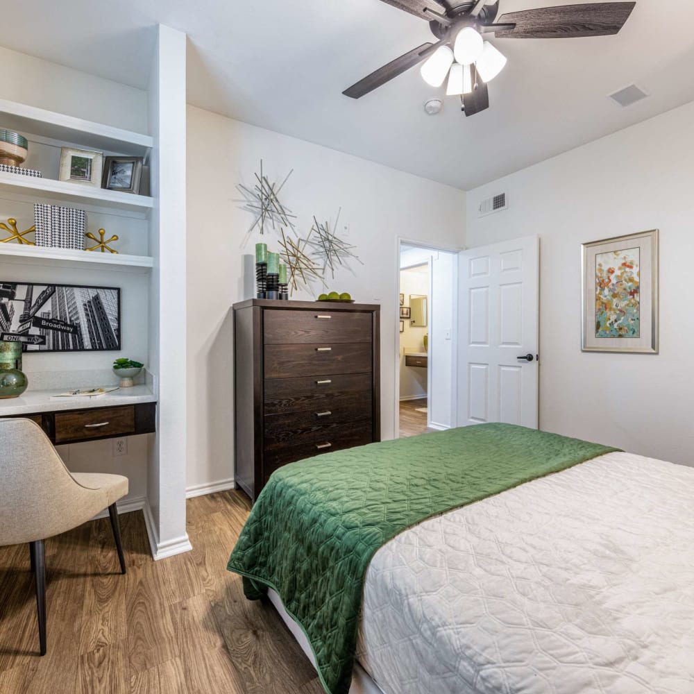Bedroom with built in shelving and a ceiling fan at The Pines on Spring Rain in Spring, Texas