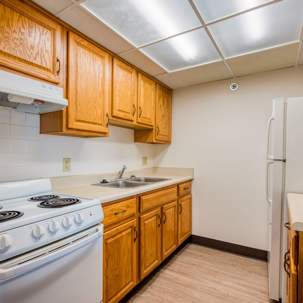 Model kitchen with wood cabinets at Cambridge Towers in Detroit, Michigan