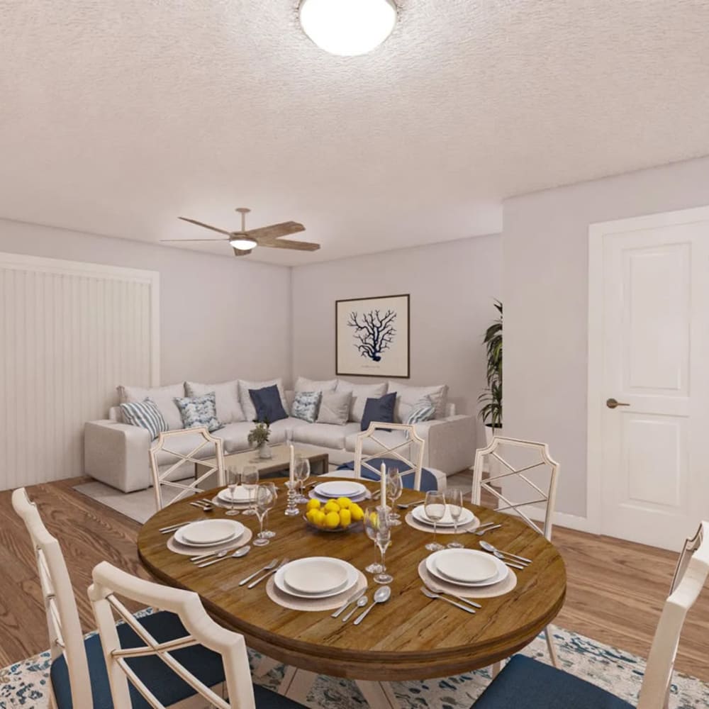 Render of a dining table and living room in a model home at The Cordelia in Fort Walton Beach, Florida