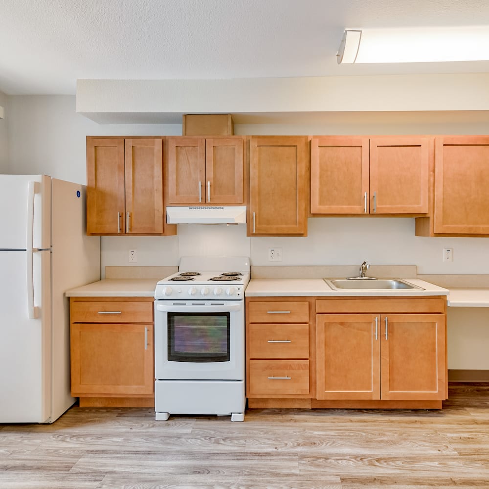 Modern kitchen with wood cabinets at Drehmoor Apartments in Denver, Colorado