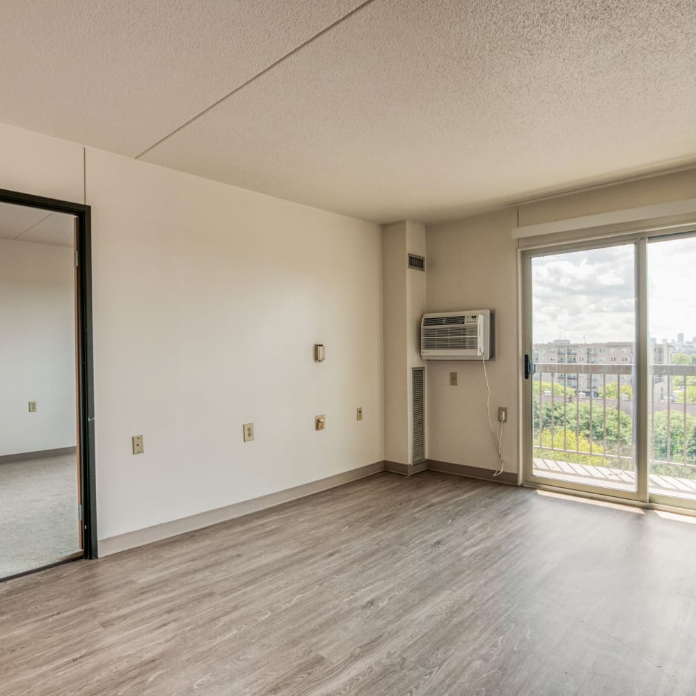 Model living room with a large window at Village Center in Detroit, Michigan