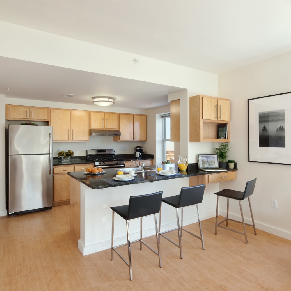 Model kitchen with counter seating at Metro Green Residences in Stamford, Connecticut