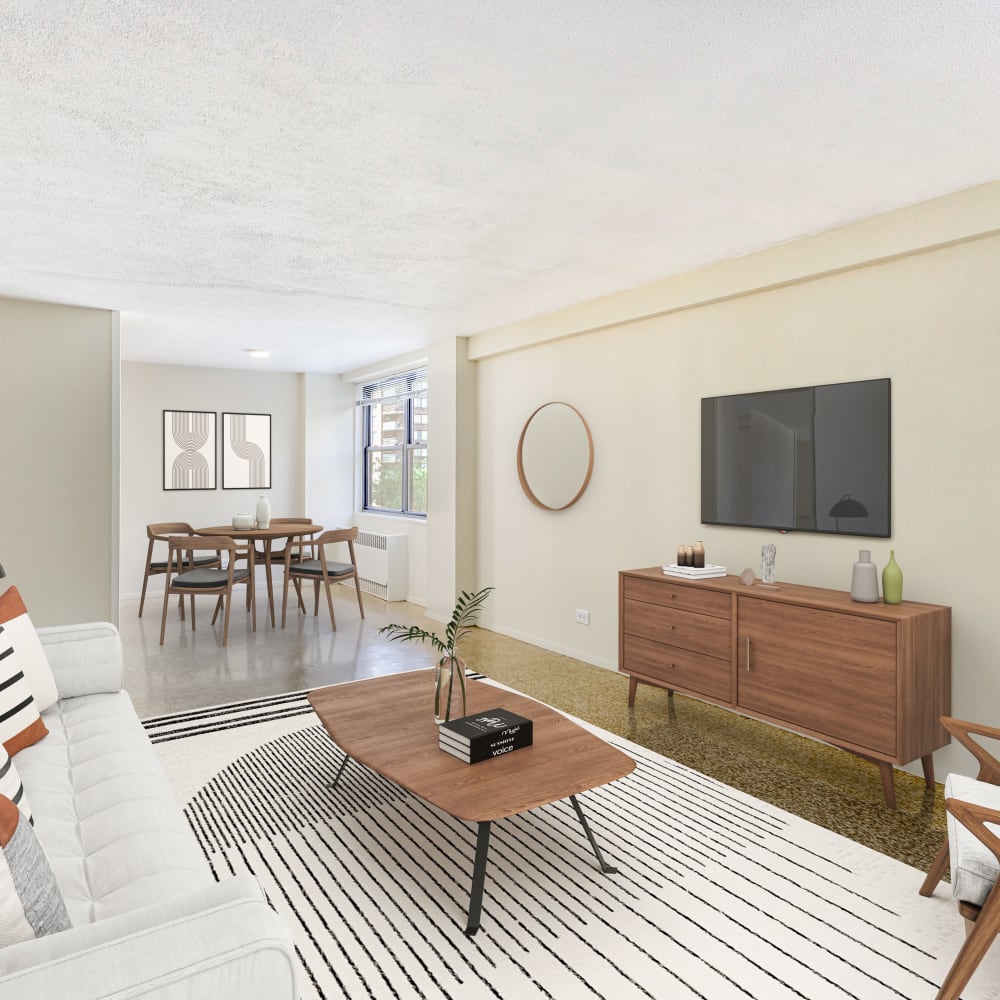 Model living space leading towards dining area at Tower West Apartments in New York, New York