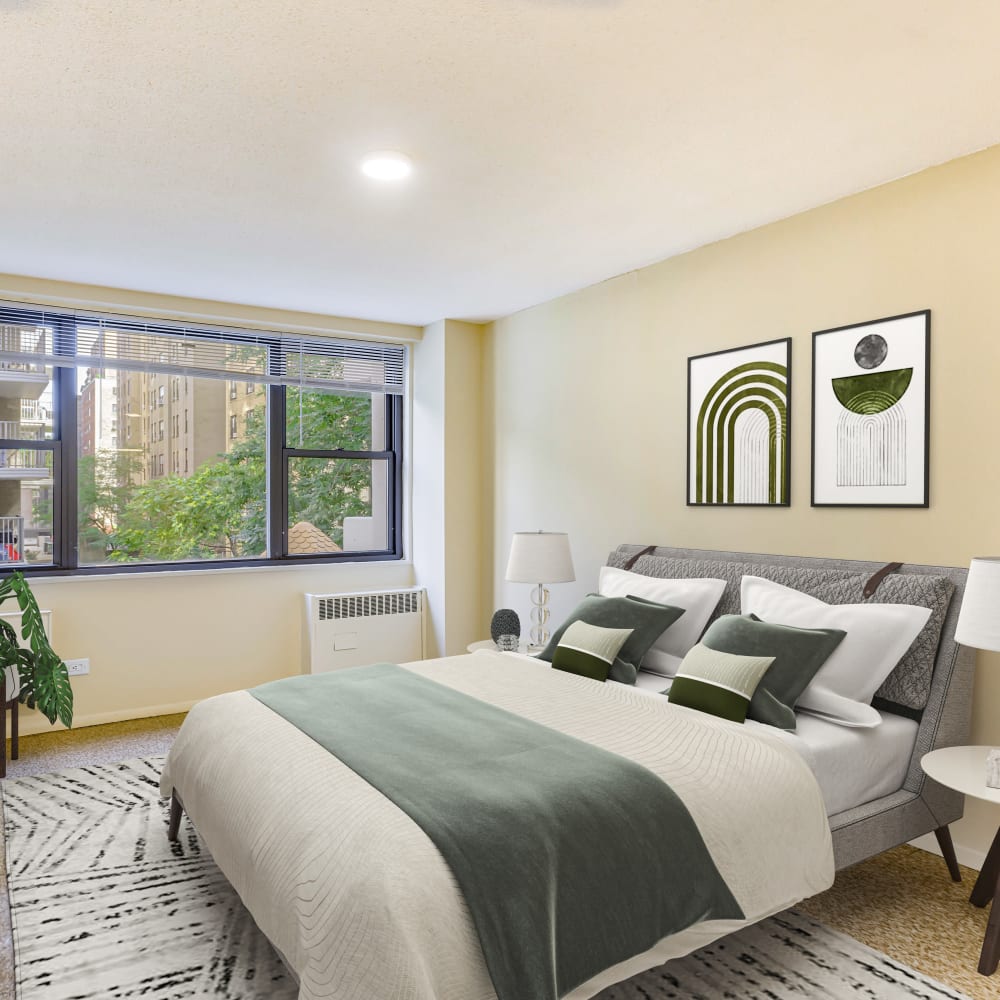 Model bedroom with green accents at Tower West Apartments in New York, New York