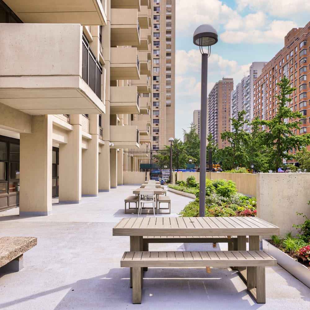 Walkway with picnic benches at Tower West Apartments in New York, New York