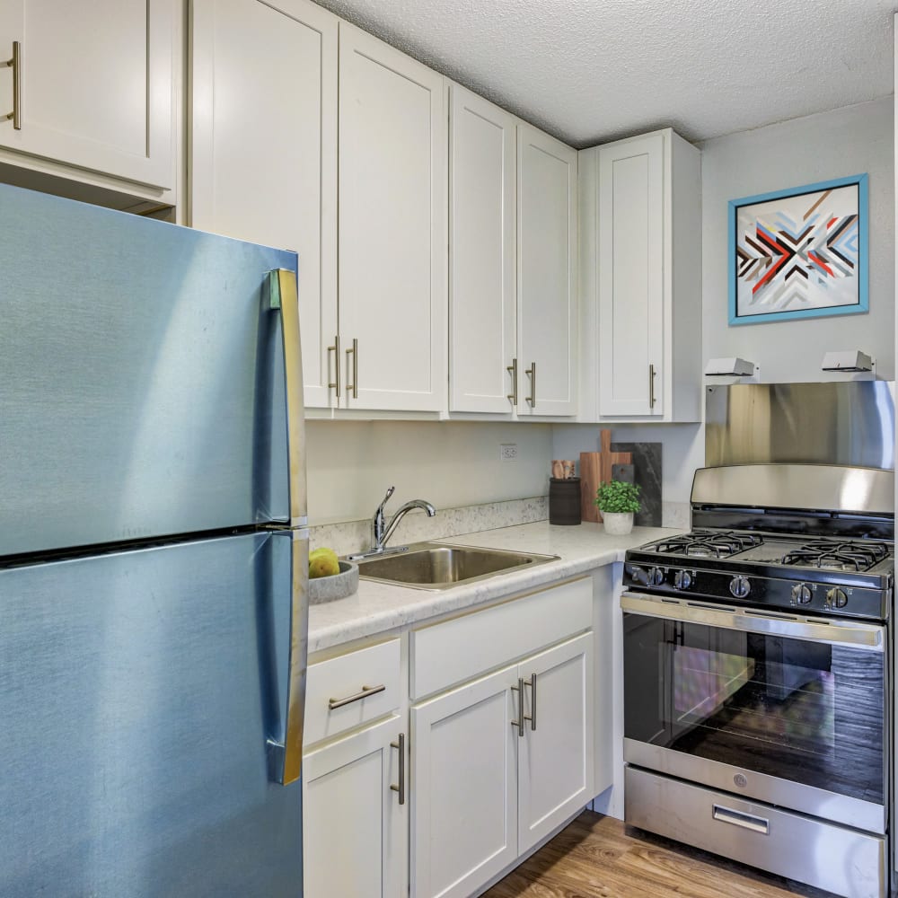 Model kitchen with blue fridge at Goodwill Terrace in Astoria, New York