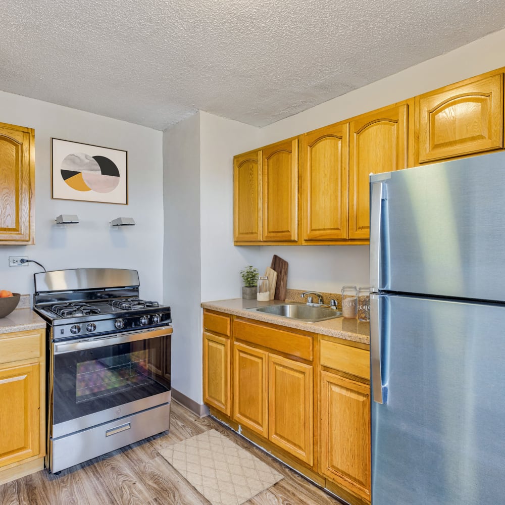 Model kitchen with modern appliances and wood accents at Goodwill Terrace in Astoria, New York