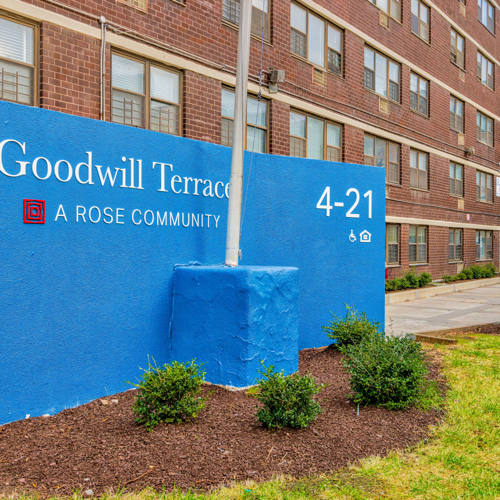 Exterior blue sign at Goodwill Terrace in Astoria, New York