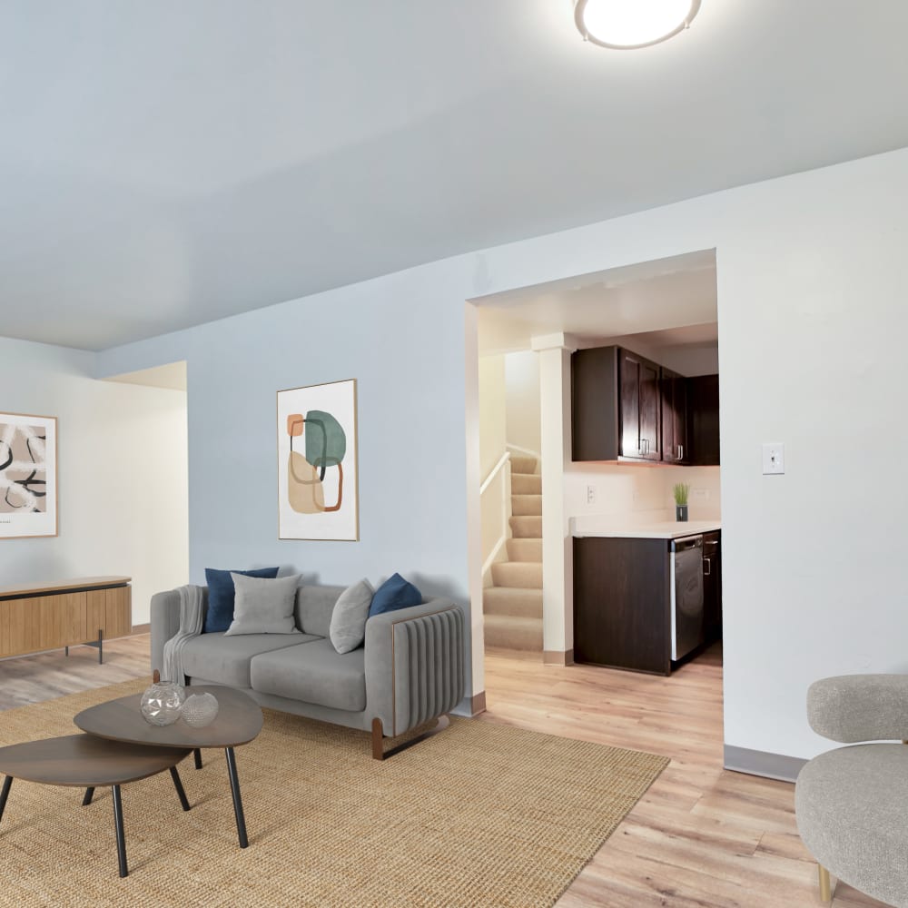 Model living room with a grey couch at BJ Wright Court Apartments in Chicago, Illinois