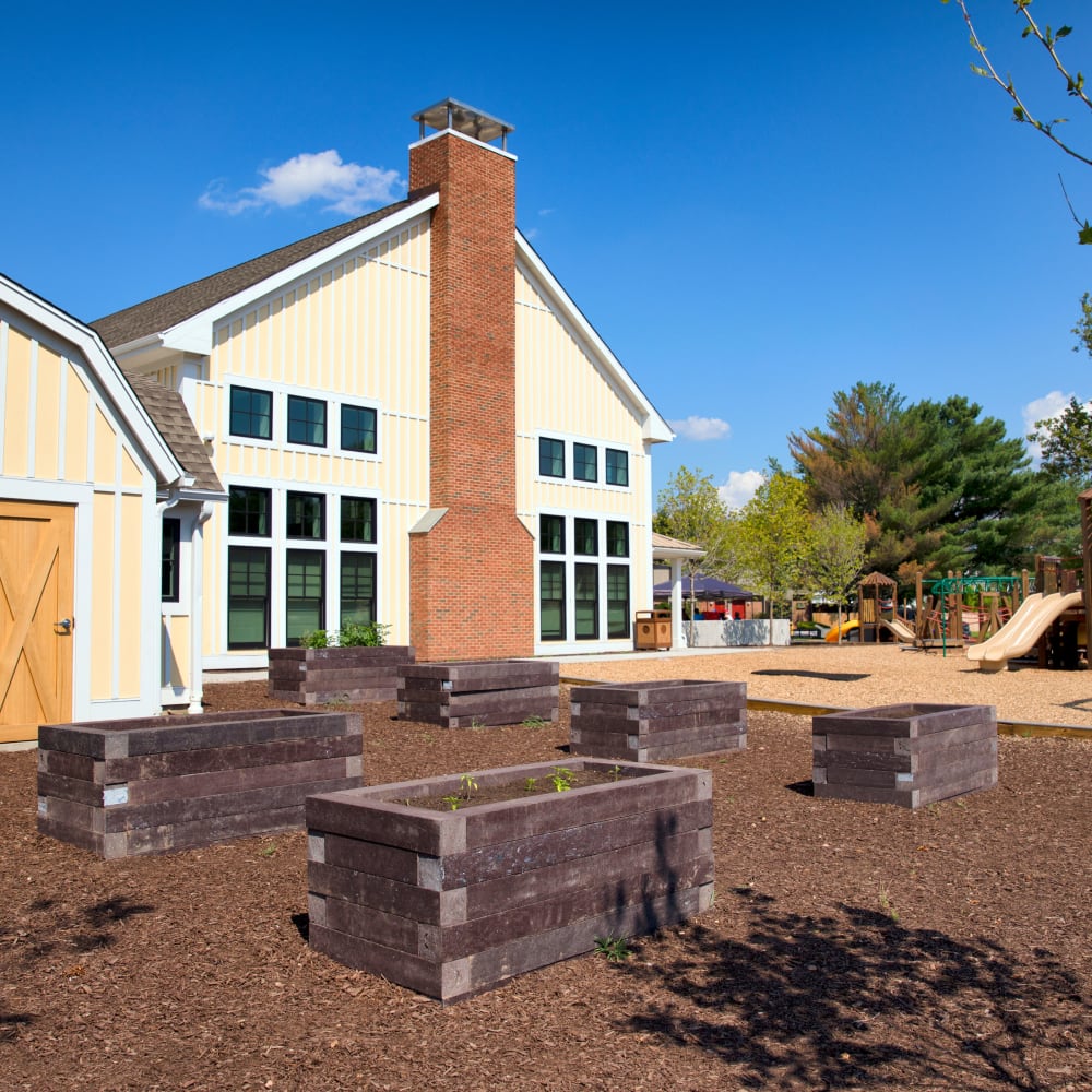Exterior of building with gardening beds at Squire Village in Manchester, Connecticut
