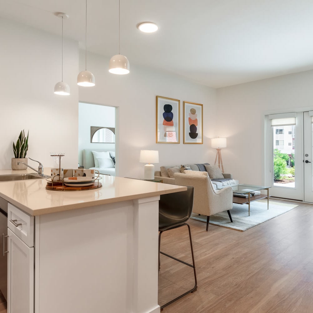 Model kitchen leading into living space at Metro Green Court in Stamford, Connecticut