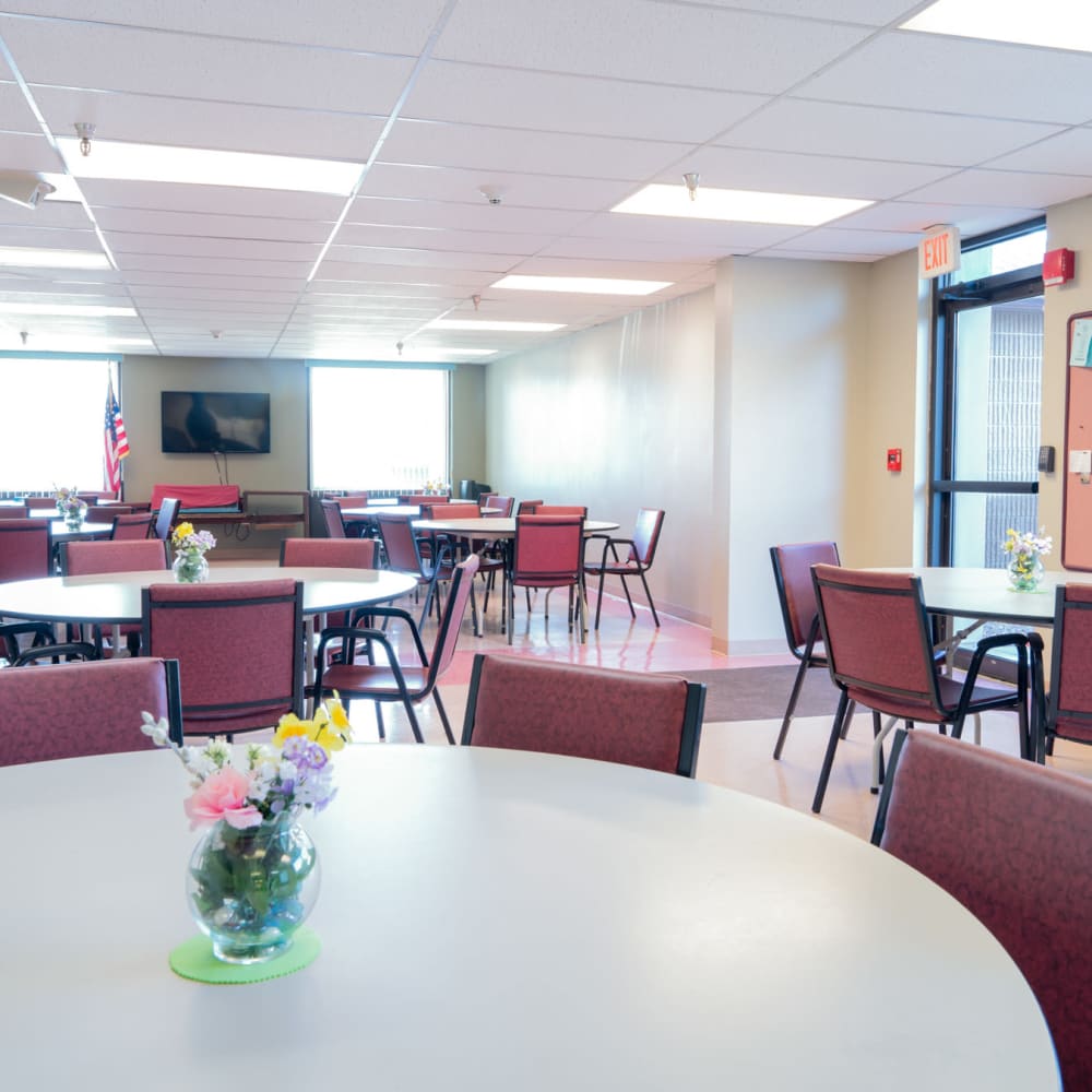 Community room with tables at Village Square Apartments in Williamsville, New York