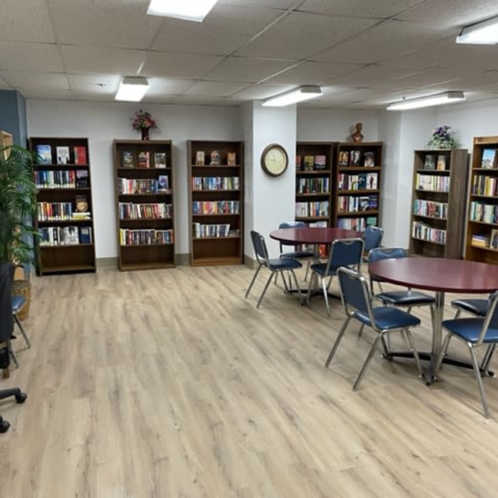 Community library with tables at Farmington Place in Farmington, Michigan