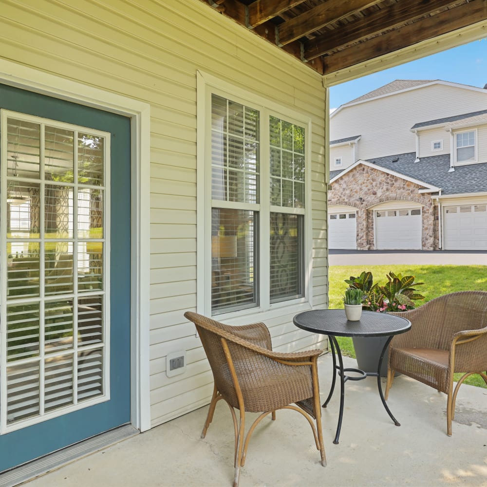 Outdoor seating on an apartment patio at The Courts of Avalon in Pikesville, Maryland