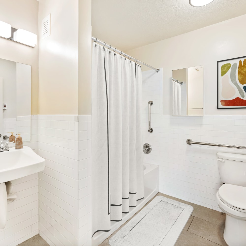 Bathroom with a vanity and tub/shower combination in a model home at Grace West Manor Apartments in Newark, New Jersey