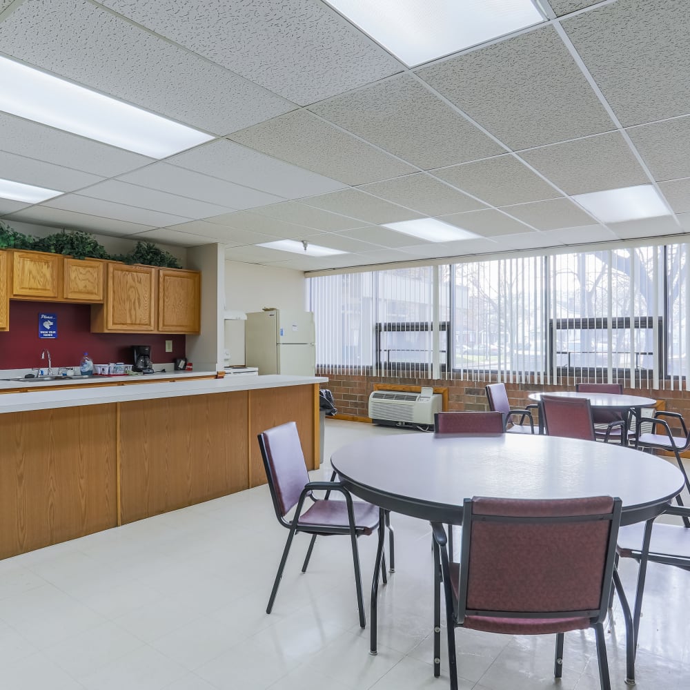 Community room kitchen with tables at Coraopolis Towers in Coraopolis, Pennsylvania