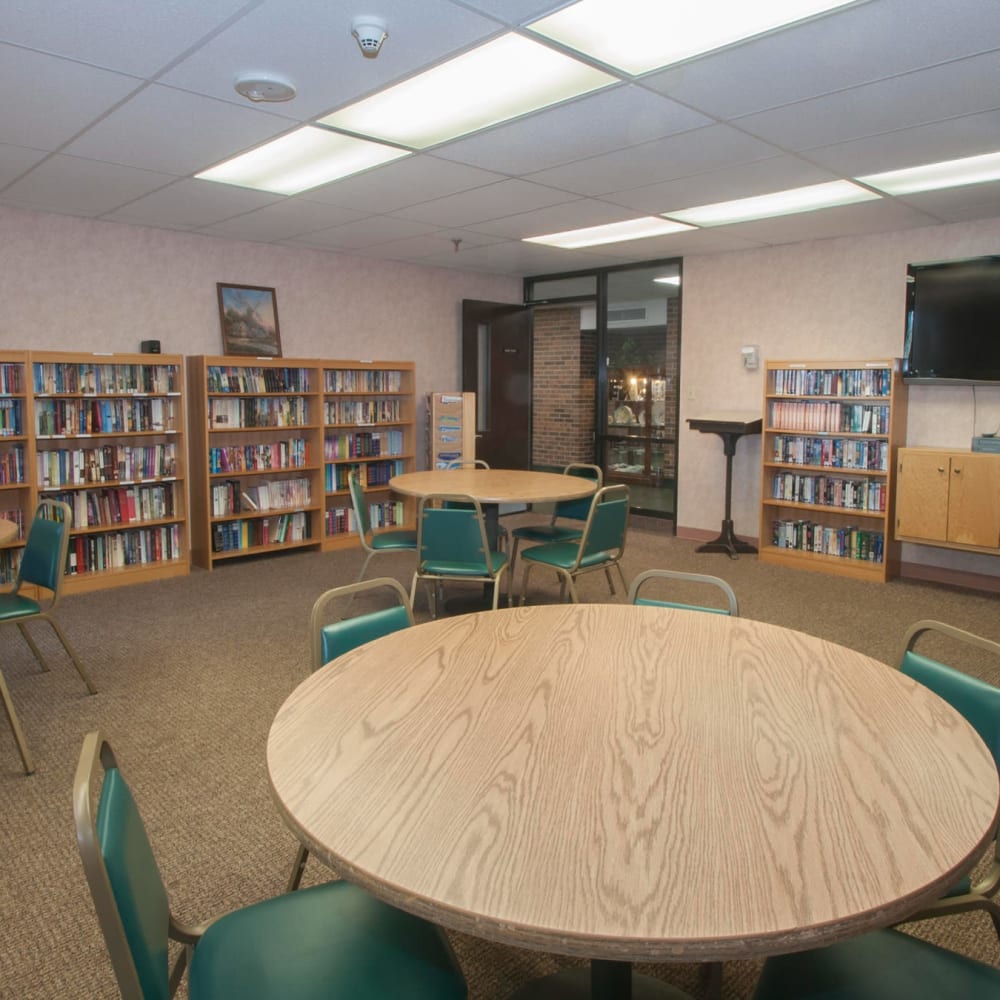 Resident library with round tables at Pine Grove Manor in Muskegon, Michigan