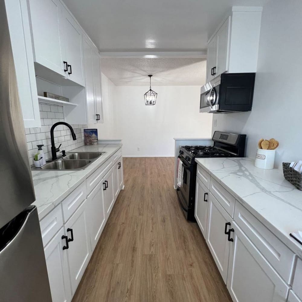 Kitchen with wood-style flooring at Langdon Park at Baldwin Village in Los Angeles, California