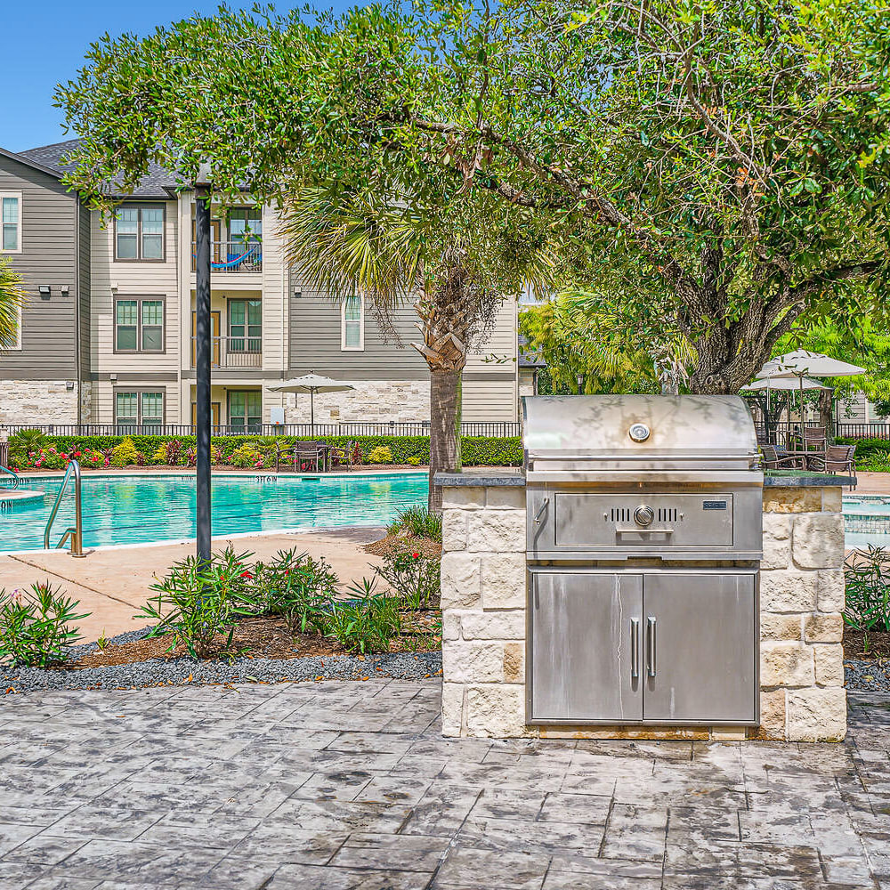 Poolside BBQ machines and grilling area at Discovery at Kingwood in Kingwood, Texas