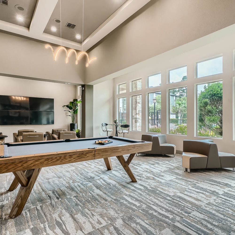 Billiard table for playing pool and lounge area at Discovery at Kingwood in Kingwood, Texas