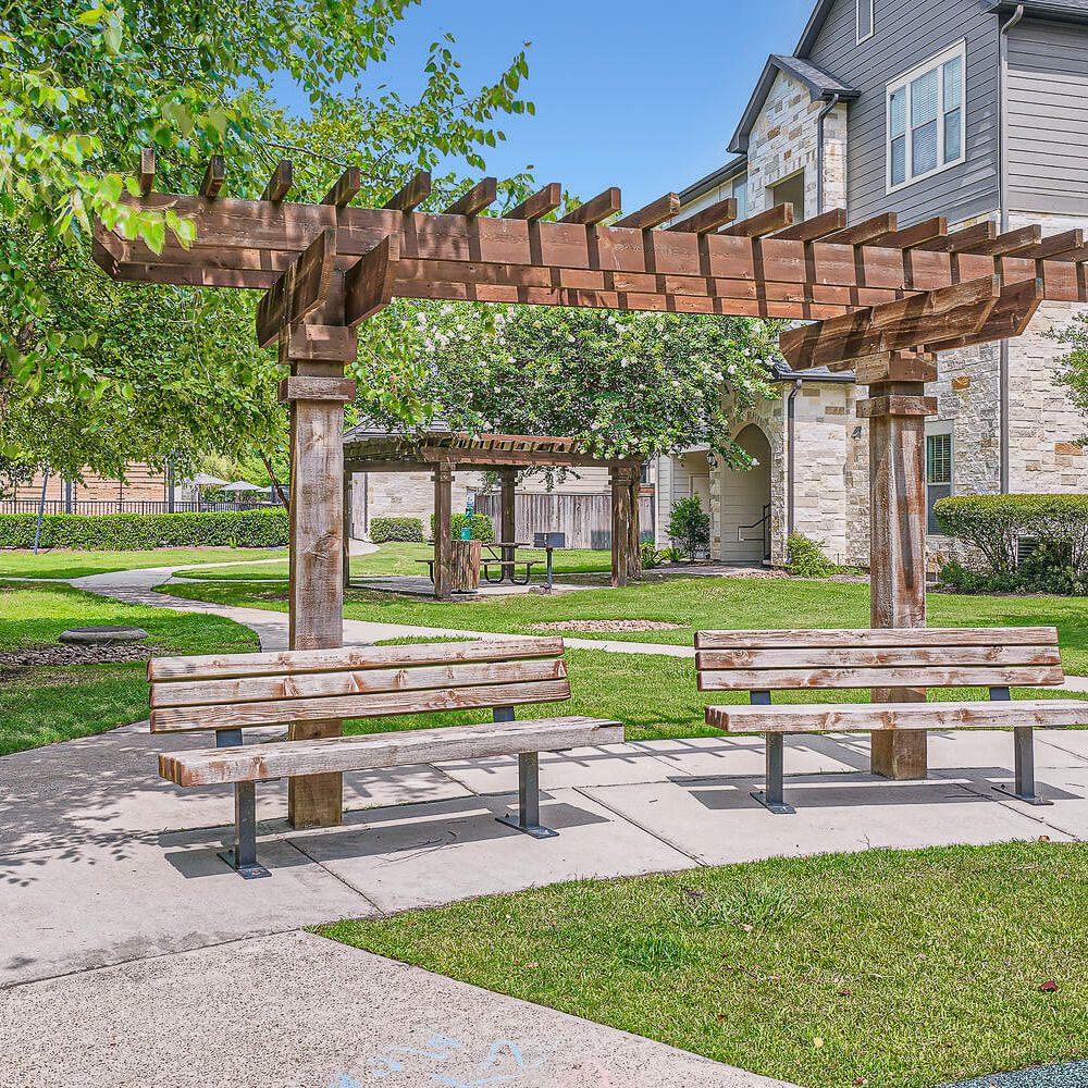 Garden style community with benches and shaded pergolas at Discovery at Kingwood in Kingwood, Texas
