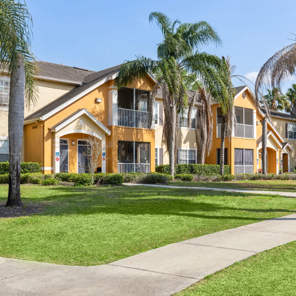 Lush landscape and the exterior of Citrus Tower | Apartments in Clermont, Florida