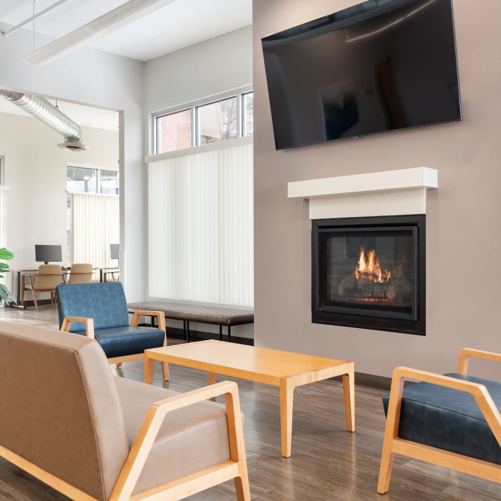 Clubhouse lounge with a fireplace at Juanita Nolasco Residences in Denver, Colorado