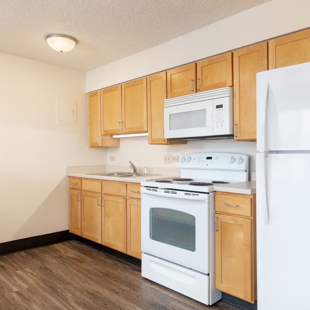 Kitchen with appliances at Juanita Nolasco Residences in Denver, Colorado